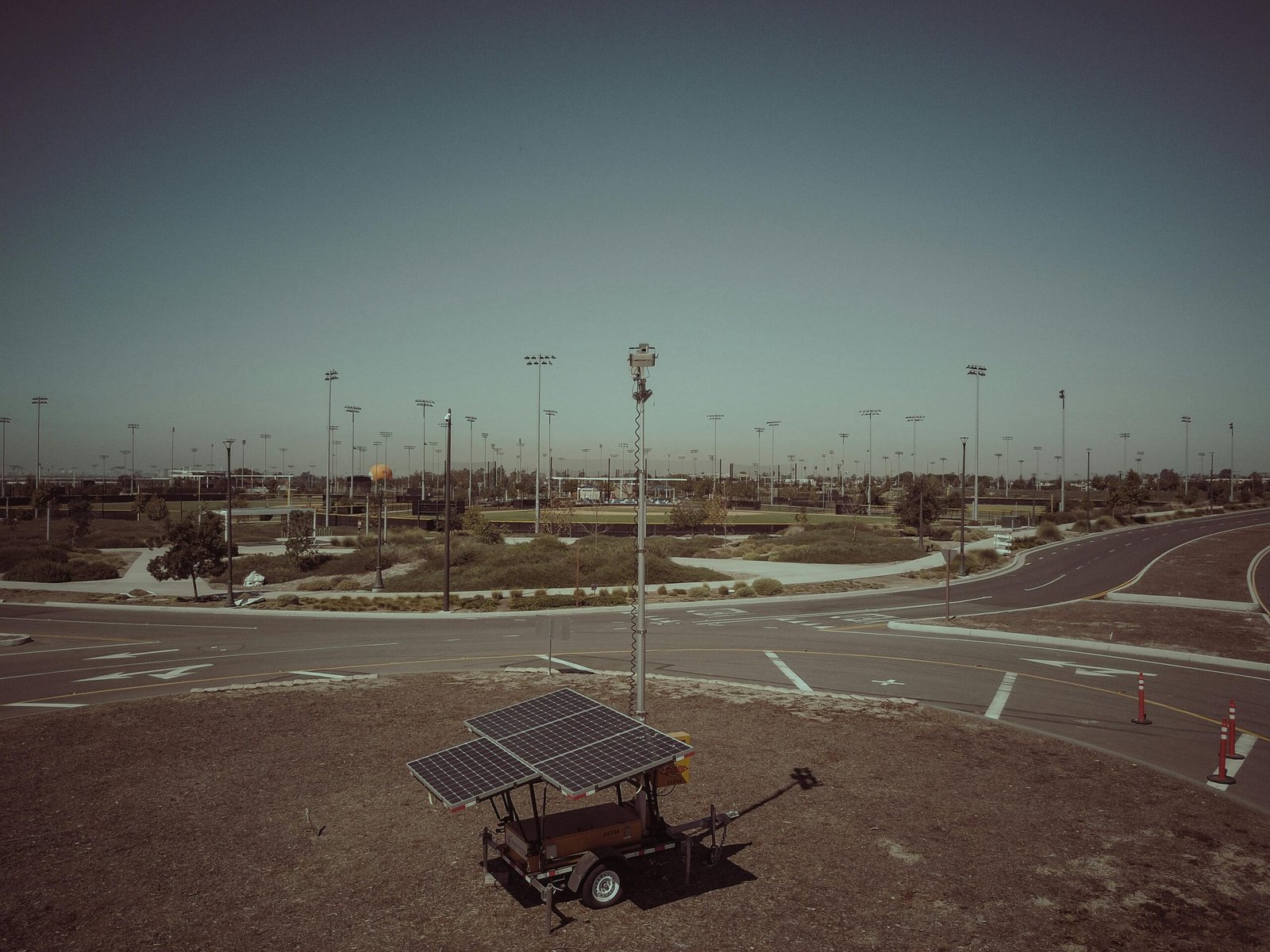 A mobile solar power unit in an open field area captures clean energy.